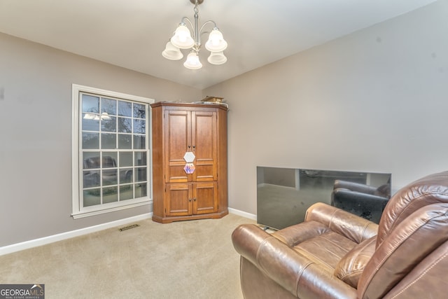 living area with light colored carpet and an inviting chandelier