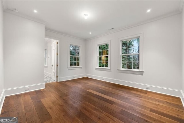 spare room featuring crown molding, dark wood-style floors, baseboards, and recessed lighting