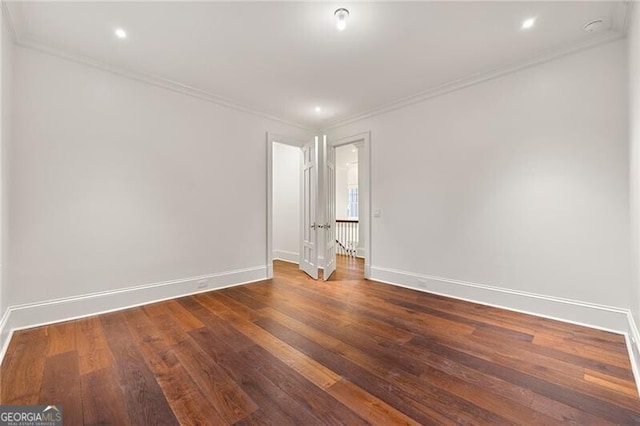 unfurnished room featuring dark wood finished floors, baseboards, recessed lighting, and crown molding