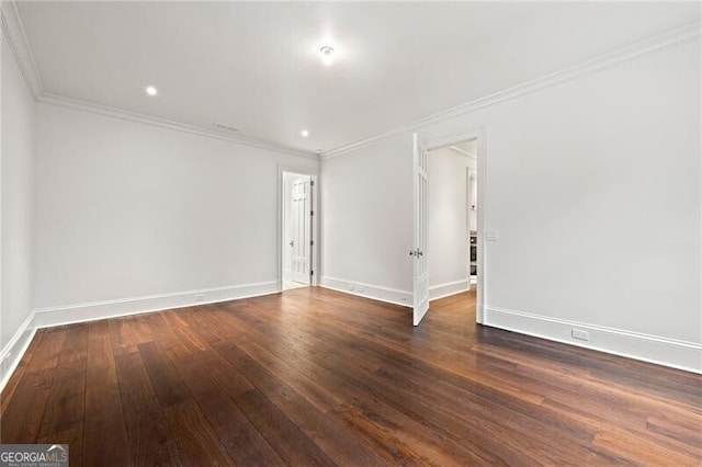 empty room featuring baseboards, crown molding, and dark wood-style flooring