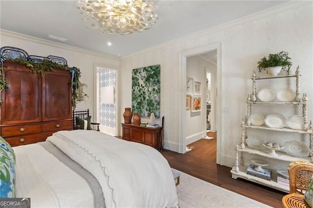 bedroom featuring dark wood finished floors, baseboards, an inviting chandelier, and ornamental molding