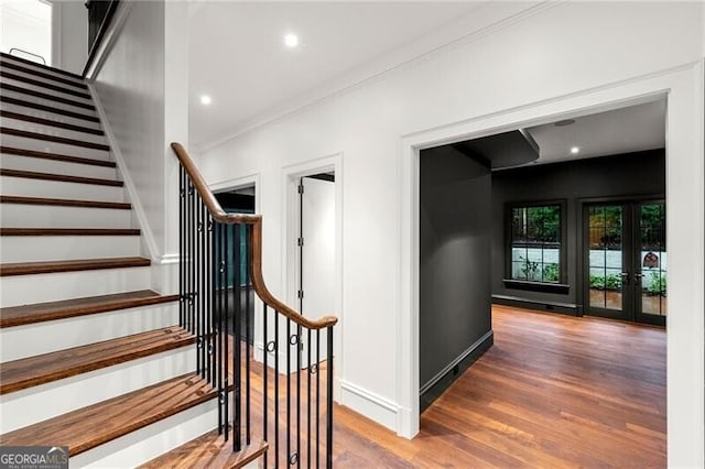 staircase featuring french doors, recessed lighting, wood finished floors, ornamental molding, and baseboards