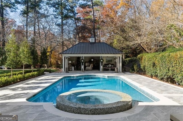 view of pool featuring a patio area and a pool with connected hot tub