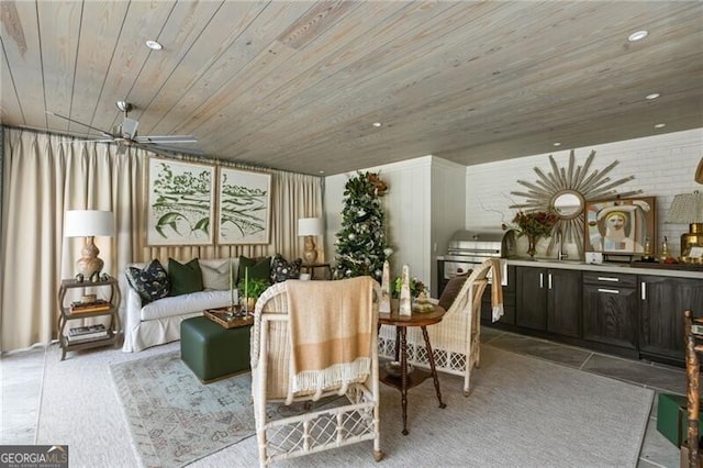 sitting room with ceiling fan, recessed lighting, and wood ceiling