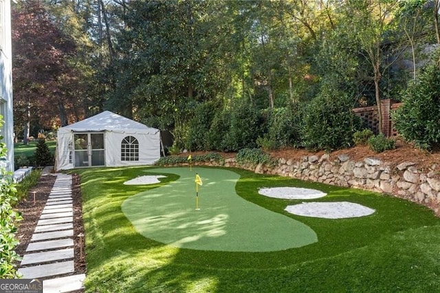 view of yard featuring an outdoor structure and golf course view