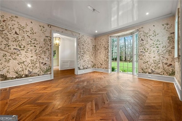 unfurnished room featuring wallpapered walls, ornamental molding, and baseboards