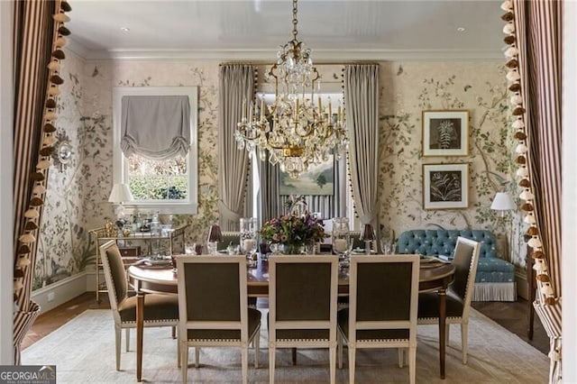 dining space featuring wallpapered walls, a notable chandelier, ornamental molding, and baseboards