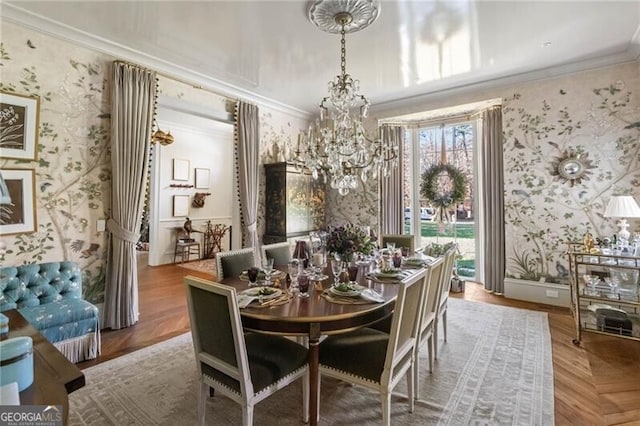 dining area with wallpapered walls, baseboards, crown molding, and a chandelier