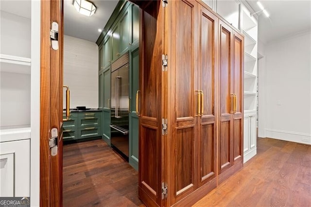 corridor with dark wood finished floors and baseboards