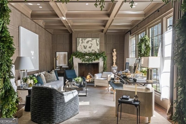 interior space with a fireplace, beamed ceiling, and coffered ceiling