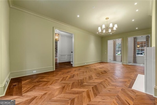 unfurnished dining area with baseboards, ornamental molding, a chandelier, and visible vents