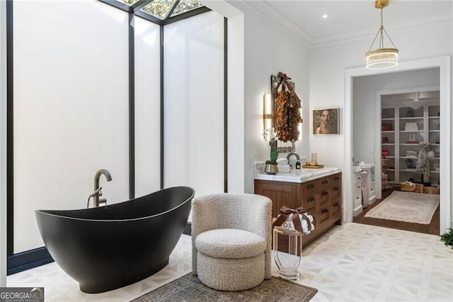 bathroom with vanity, recessed lighting, a soaking tub, and crown molding