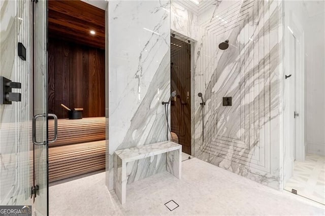 interior space with a marble finish shower, a sauna, and tile walls