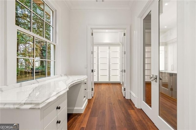 hall featuring ornamental molding, dark wood-type flooring, and french doors