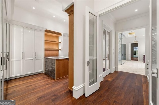 hallway featuring french doors, dark wood-type flooring, recessed lighting, and crown molding