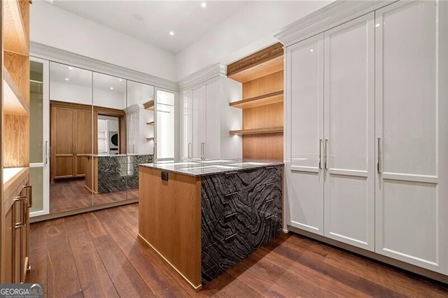 interior space featuring open shelves, dark wood-style floors, white cabinetry, and a peninsula