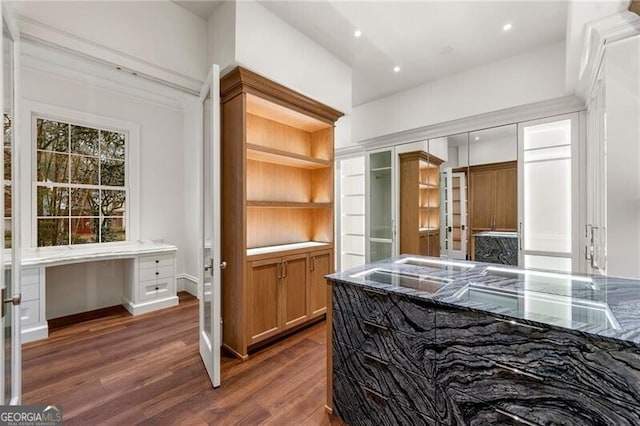 interior space featuring dark wood-style flooring and built in study area