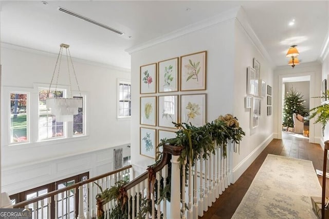 hallway featuring ornamental molding, dark wood finished floors, plenty of natural light, and baseboards