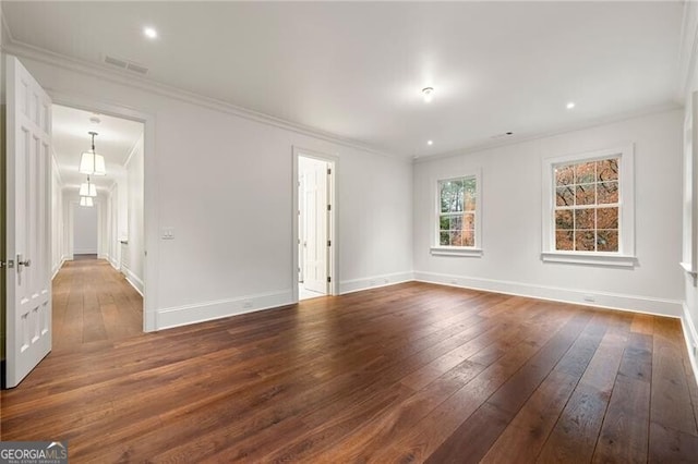 empty room with visible vents, baseboards, crown molding, dark wood finished floors, and recessed lighting