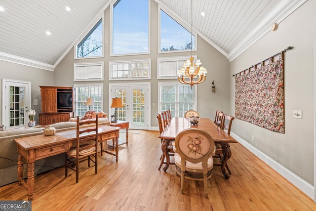 kitchen with kitchen peninsula, a kitchen bar, light wood-type flooring, ornamental molding, and stainless steel appliances