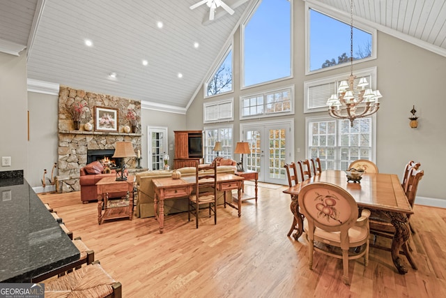 kitchen featuring a kitchen island with sink, dark stone counters, light hardwood / wood-style flooring, appliances with stainless steel finishes, and wood ceiling