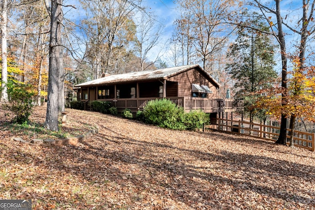 rear view of property featuring a wooden deck