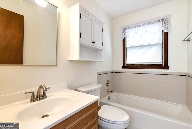 bathroom with a bath, vanity, and toilet