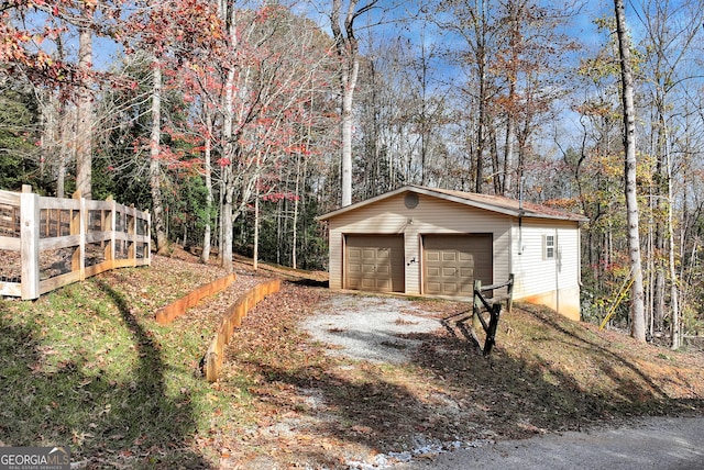 view of yard featuring a garage and an outbuilding