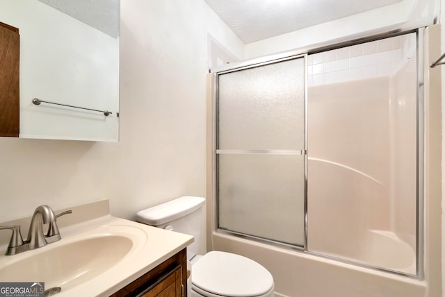 full bathroom with vanity, enclosed tub / shower combo, a textured ceiling, and toilet