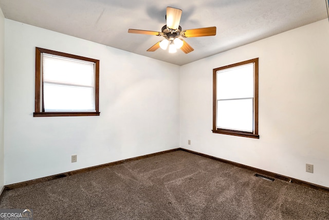 carpeted spare room with ceiling fan