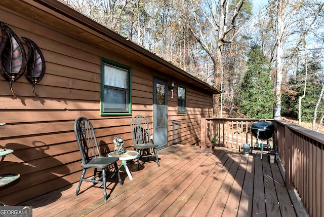 wooden deck featuring a grill