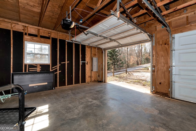 garage with electric panel and a garage door opener