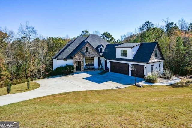 view of front of property featuring a front yard and a garage