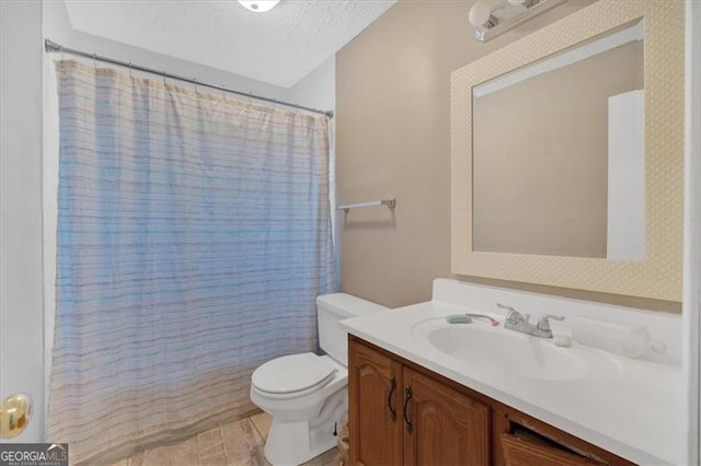 bathroom featuring vanity, toilet, a textured ceiling, and walk in shower