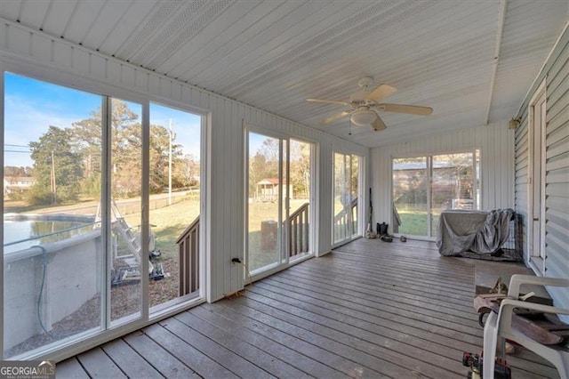 unfurnished sunroom with a wealth of natural light and ceiling fan