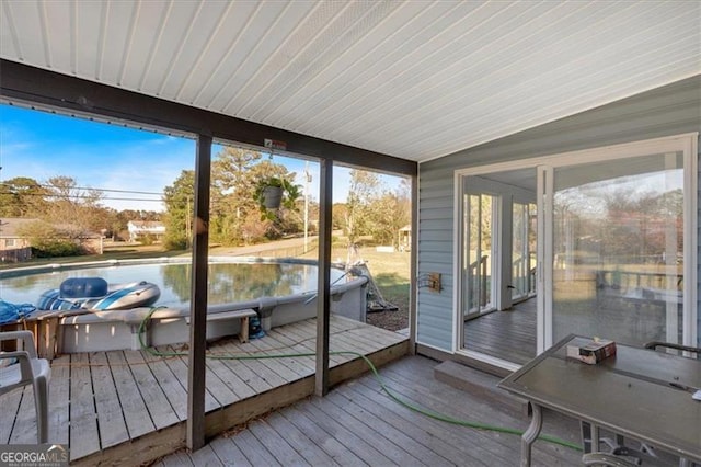 sunroom featuring lofted ceiling