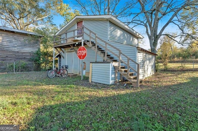 back of house featuring a yard and a wooden deck