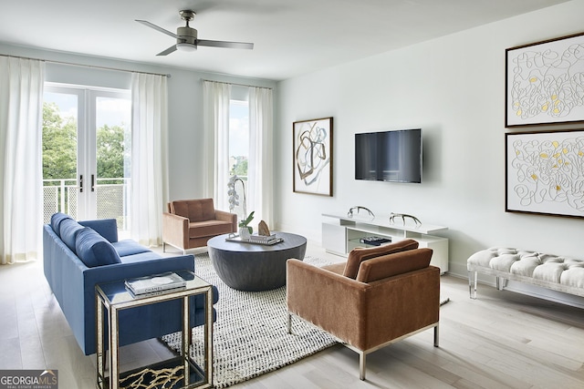 living room featuring hardwood / wood-style flooring, ceiling fan, and french doors