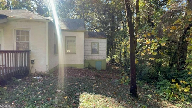 view of side of property featuring a wooden deck