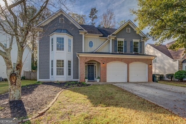 view of front of home with a front yard and a garage