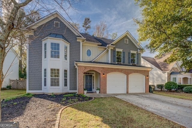 view of front of property with a garage and a front lawn