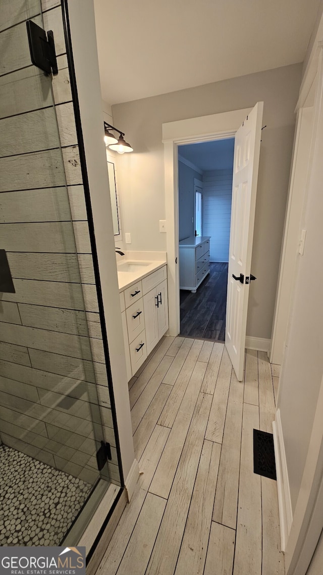 bathroom featuring vanity, hardwood / wood-style flooring, and an enclosed shower