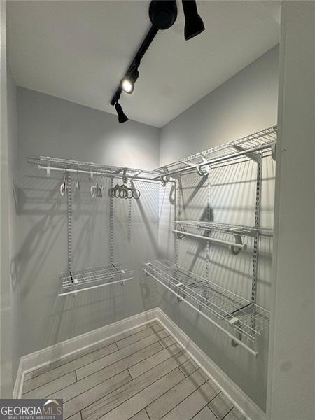 walk in closet featuring hardwood / wood-style flooring