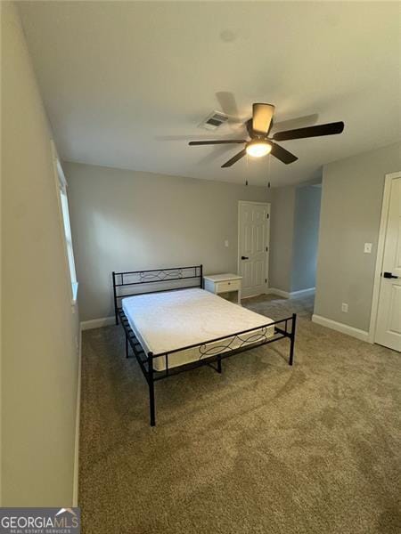 unfurnished bedroom featuring dark carpet and ceiling fan