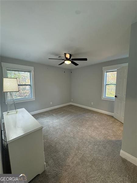 carpeted empty room with ceiling fan