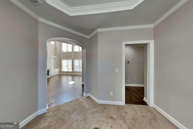 spare room featuring light hardwood / wood-style floors and crown molding