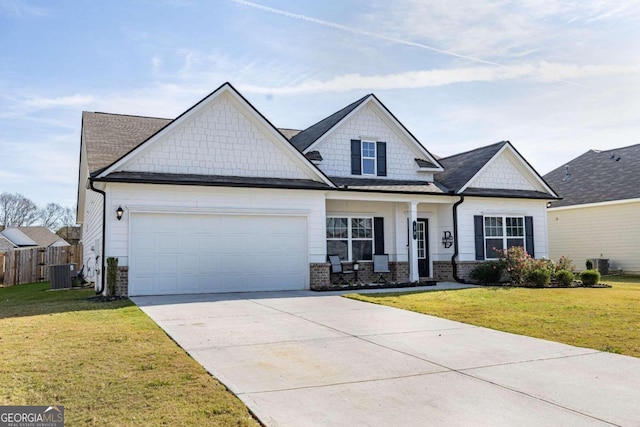 view of front of home with a front yard, a garage, and central AC unit