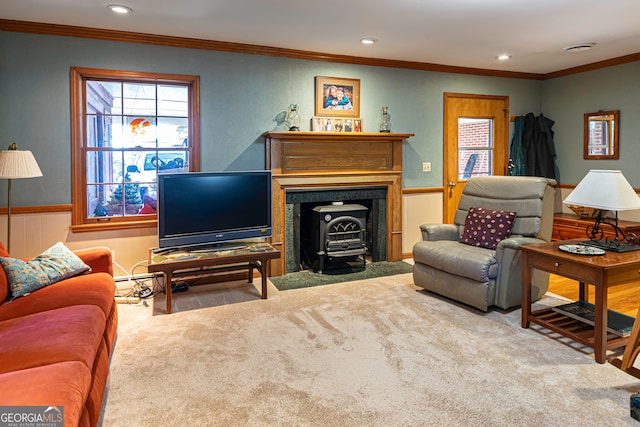 living room featuring a wood stove, ornamental molding, and carpet floors