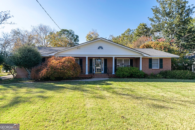 ranch-style house featuring a porch and a front yard