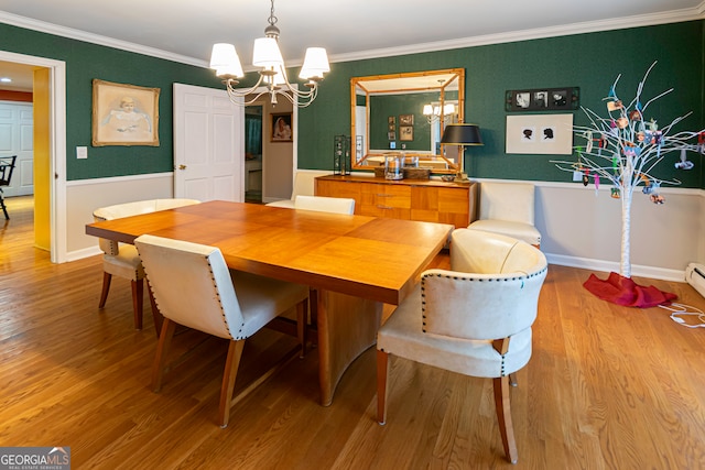 dining space featuring a baseboard radiator, an inviting chandelier, light hardwood / wood-style flooring, and crown molding